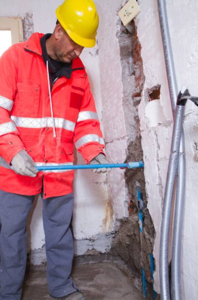 plumber at work with pipes